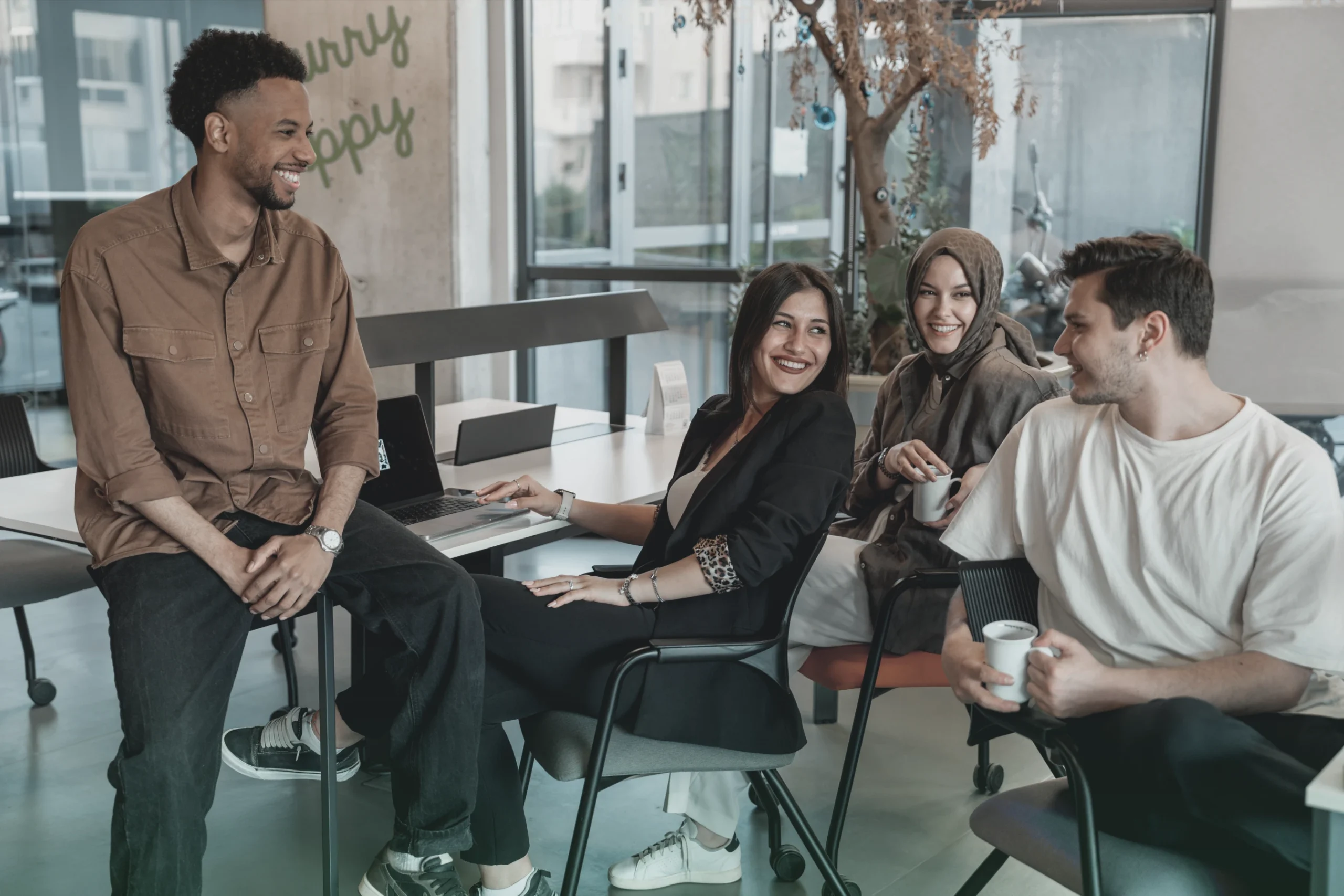 Diverse team collaborating and smiling in a casual office setting